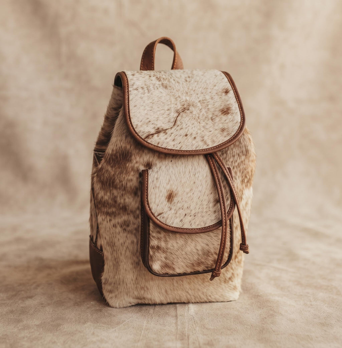 Cowhide Leather Backpack – Small Western Rucksack with Cow Print, Fringe & Conchos